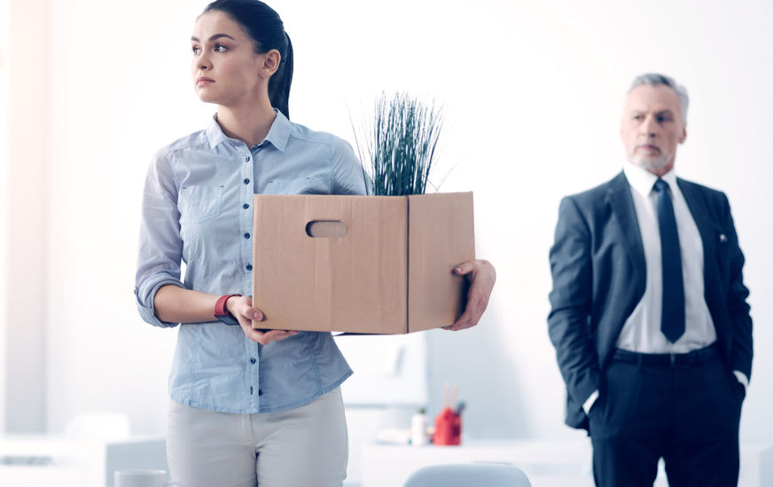 88846299 - fired young brunette with box full of stuff leaving office